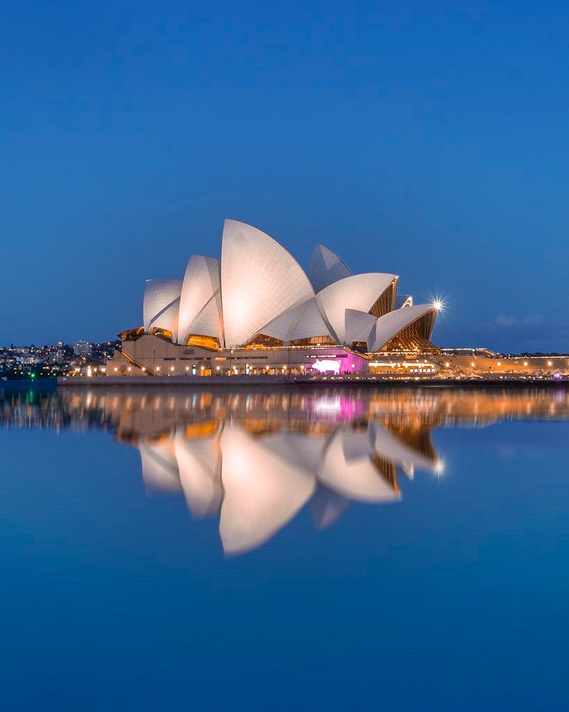 Beautiful view of the Sydney Opera House and its reflection at dusk, highlighting iconic architecture.